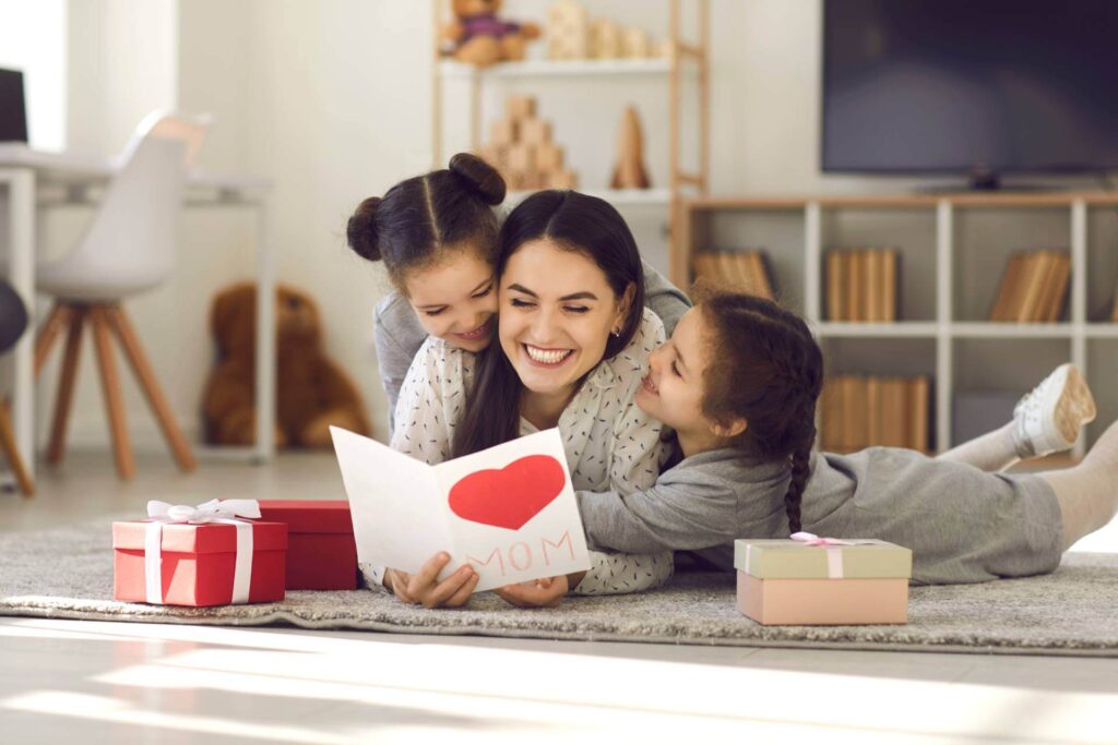 young woman getting presents from kids